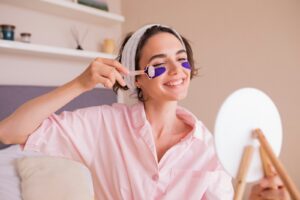 a woman in a pink shirt holding a pair of scissors