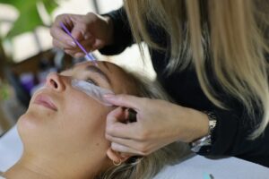 A woman getting her hair cut by a hair stylist