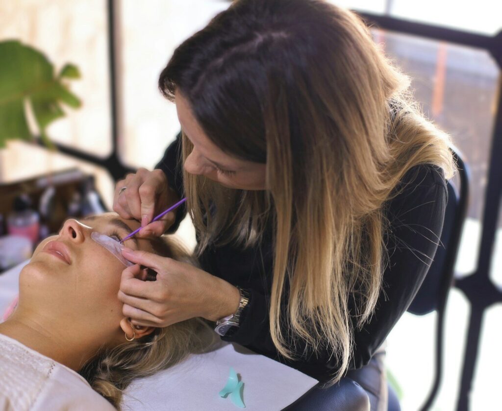 A woman is getting her hair cut by a hair stylist