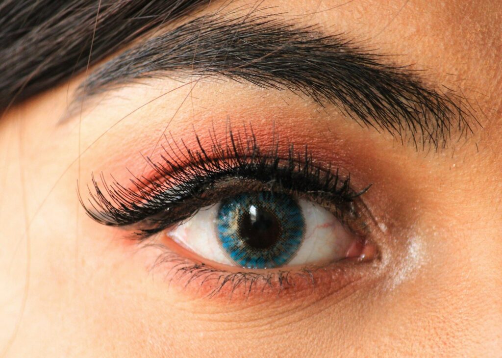 A close up of a woman's eye with long lashes
