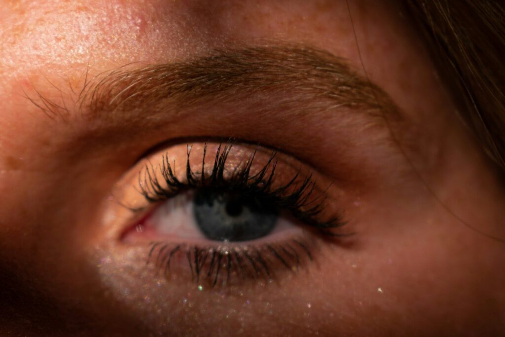 a close up of a person's eye with long eyelashes